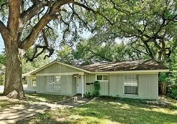 Cash Home Buyer Reviews Austin - light green sell house for cash shaded by tree