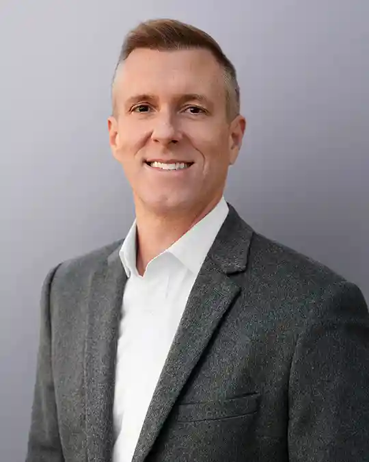 Cash House Buyer Austin, TX - headshot of Robert Grunnah in a grey suit pays cash for houses