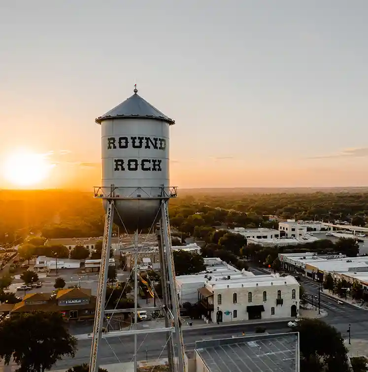 Sell My House Fast Round Rock, TX - water tower above downtown Round Rock, Texas at sunset